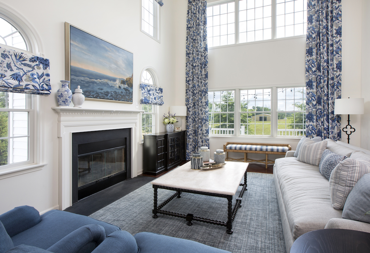 living-room-design-blue-sofa-fireplace-custom-window-treatments